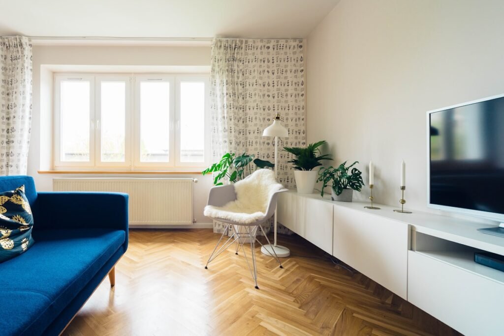 Minimal living room with lounge chair and soft daylight at Harbor Point Apartment